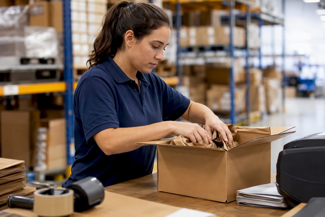Warehouse worker packing an ecommerce box